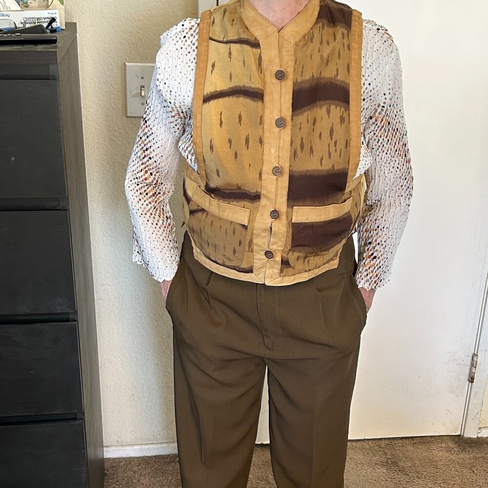 tan and brown vest paired with olive green pants.